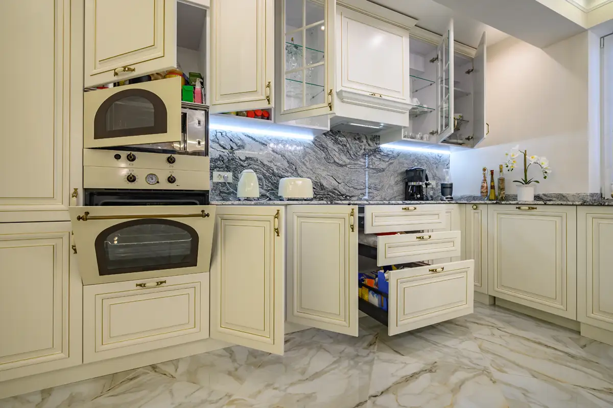 A custom kitchen with stone counters and wood cabinets.